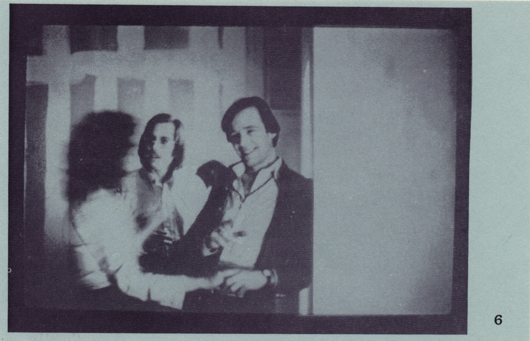 black and white image of three people engaged in coversation