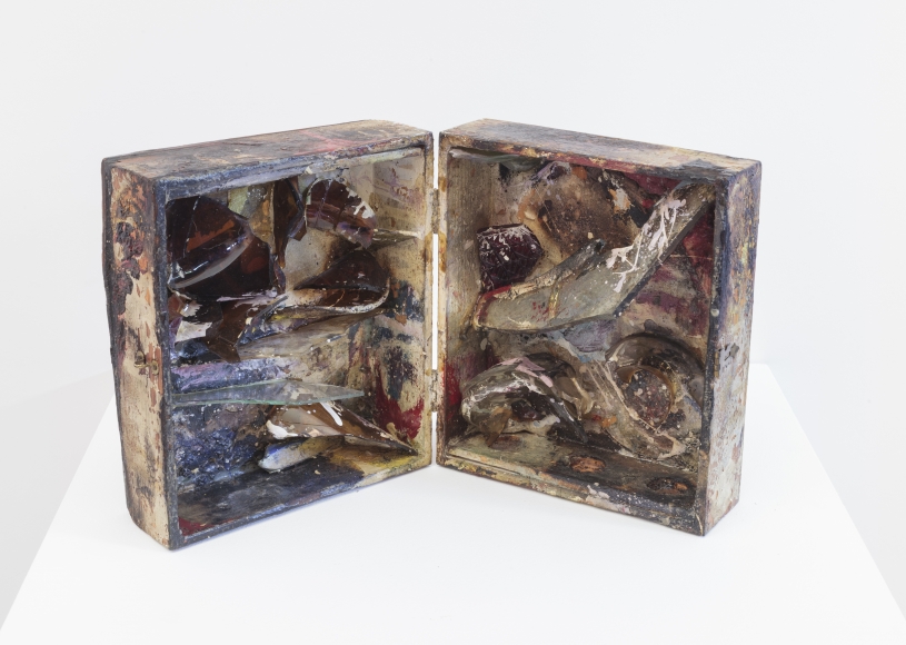 open wooden box filled with shards of glass and mirror and paint splatters of all colors