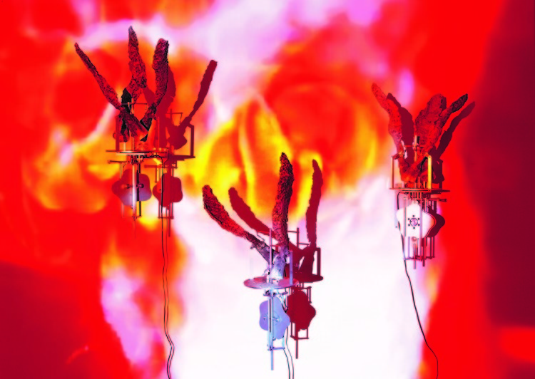 Three mechanical units made of aluminum sprawl upwards. The background is made of red, pink, white, and yellow light constructing abstract, organic shapes.