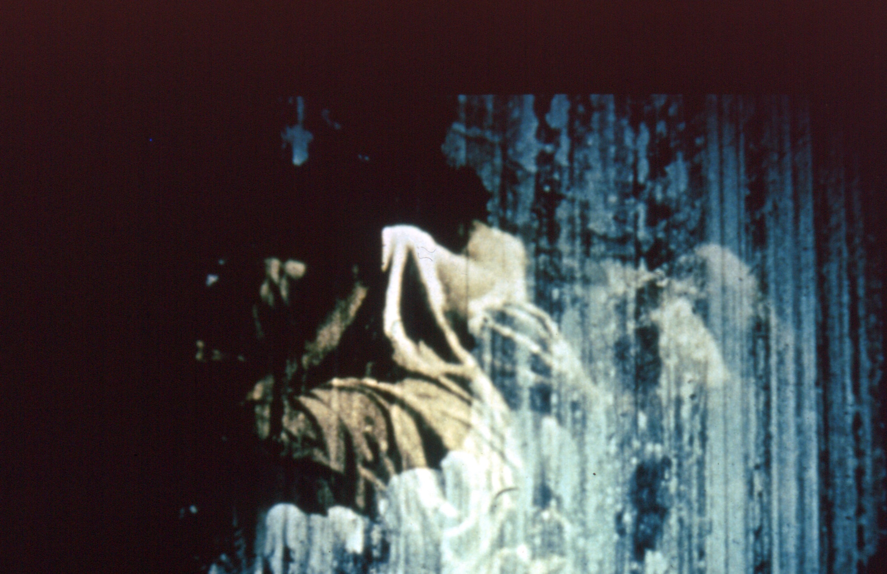 figures wrapped in fabric behind a blue, waterfall-like filter