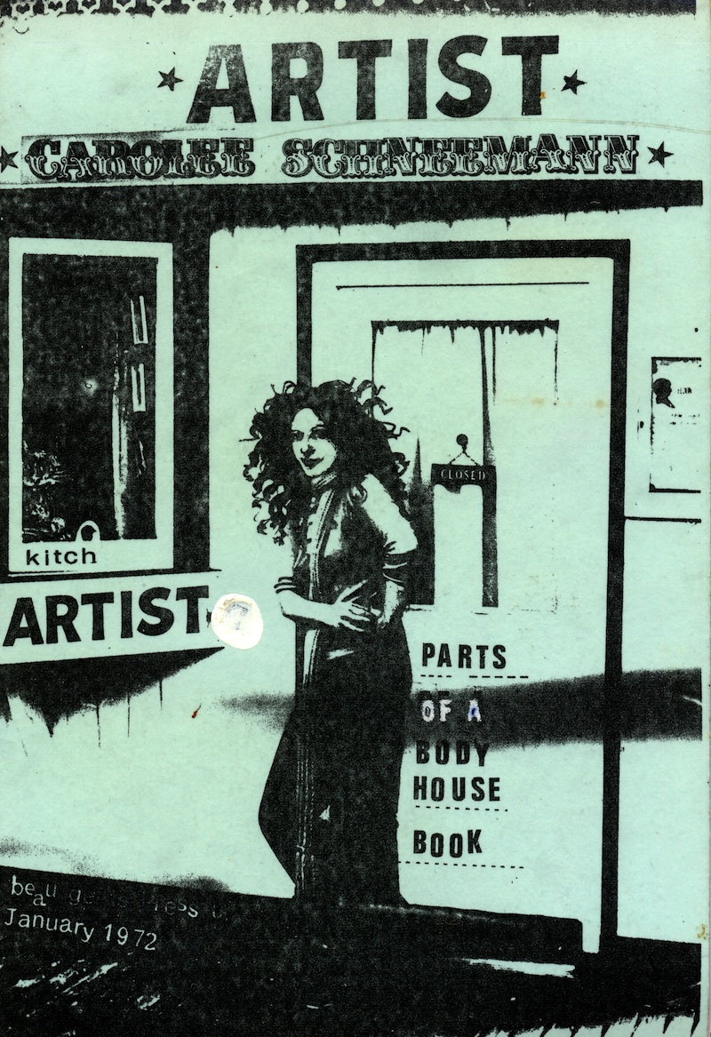 black and white stylized print; the artist is in full view facing the viewer in front of a door and a large print of kitch