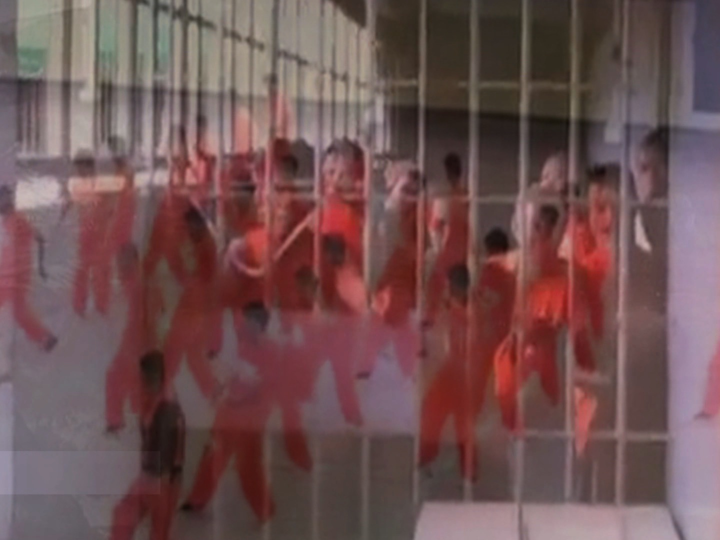 image of figures in red jumpsuits dancing superimposed with image of jail cell