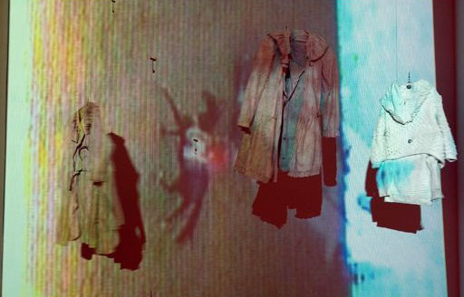 multimedia installation with motorized sculptures (clothing the moves on pulleys) and projections of horses running